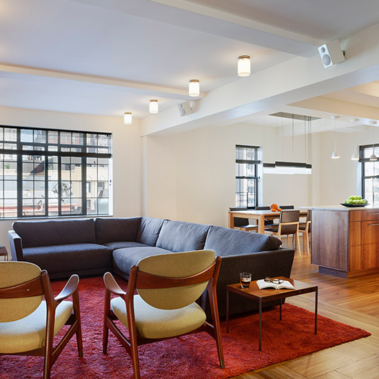 This renovation and combination of three studios and a one-bedroom unit creates an open, loft like three-bedroom apartment with views of Central Park.